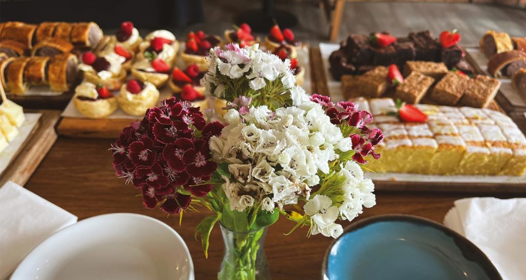 Forage at Wadswick Country Store event catering. Scones and cakes on a table.